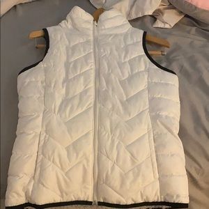 white zip up vest with grey fuzz